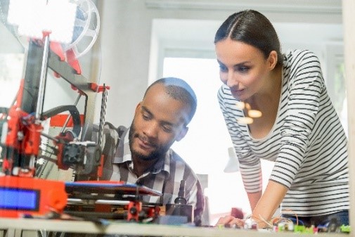 man and woman working on developing a mechanical prototype
