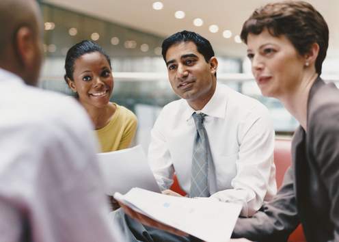 Small group of people speaking in meeting