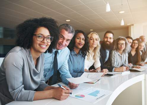 colleagues smiling at a desk