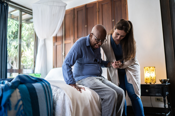 Home Health Aide helping elderly man