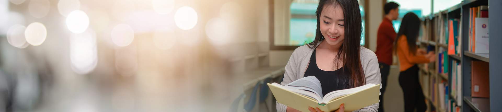 Woman in library reading book